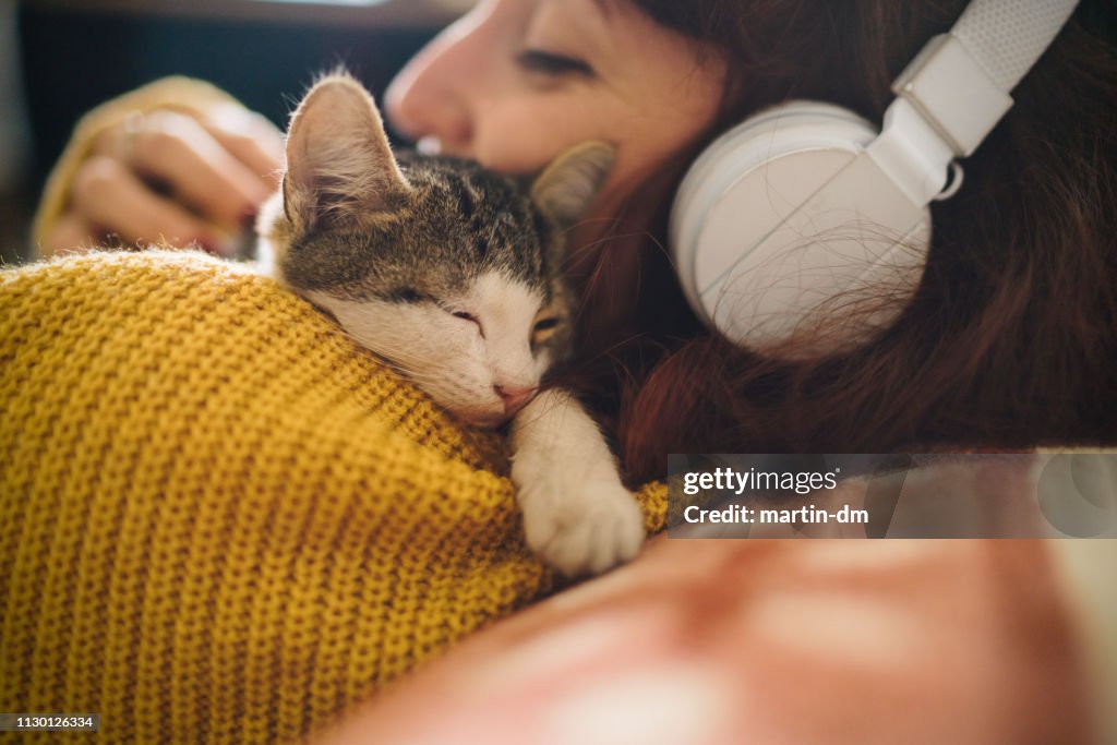 Relaxed girl with cat at home