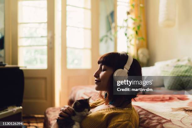 girl spending the weekend at home - headphones eyes closed stock pictures, royalty-free photos & images