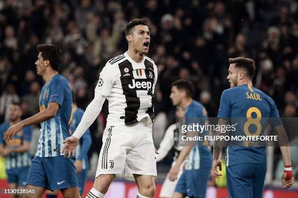 Juventus' Portuguese forward Cristiano Ronaldo celebrates after opening the scoring during the UEFA Champions League round of 16 second-leg football...