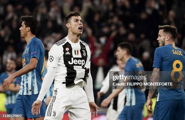 Juventus' Portuguese forward Cristiano Ronaldo celebrates after opening the scoring during the UEFA Champions League round of 16 second-leg football...