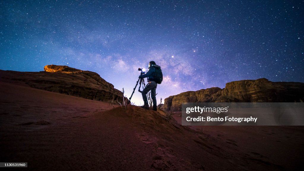 An unidentified photographer in Wadirum desert under the milky way, Jordan