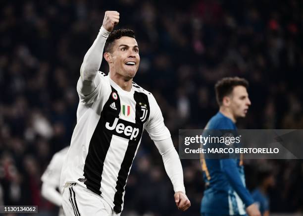 Juventus' Portuguese forward Cristiano Ronaldo celebrates after scoring 2-0 during the UEFA Champions League round of 16 second-leg football match...