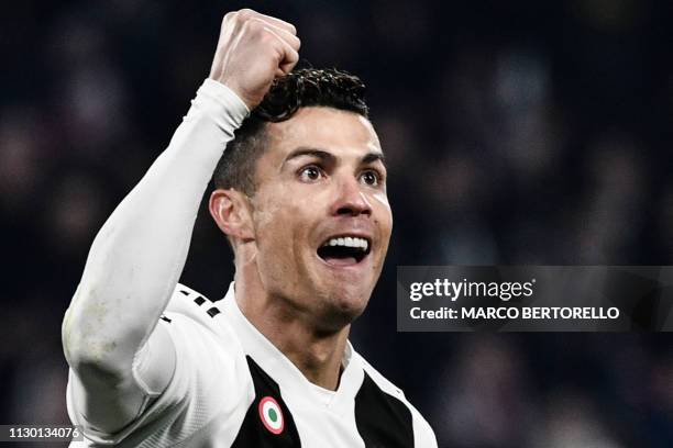 Juventus' Portuguese forward Cristiano Ronaldo celebrates after scoring 2-0 during the UEFA Champions League round of 16 second-leg football match...