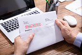 Person Holding Final Notice Invoice In Envelope