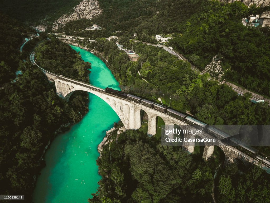 Drone Shot of Historical Old Train Passing Solkan Stone Bridge over Soča River