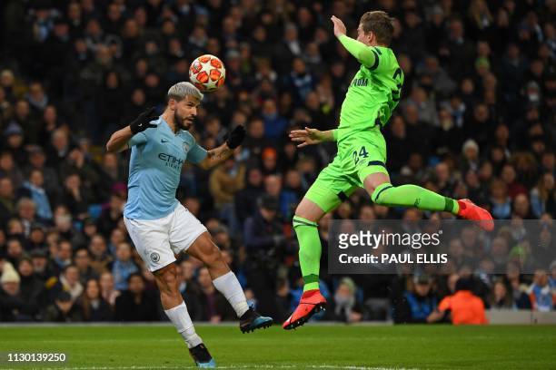 Manchester City's Argentinian striker Sergio Aguero heads towards goal under pressure from Schalke's German defender Bastian Oczipka during the UEFA...