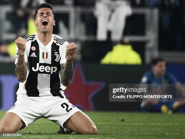 Juventus' Portuguese defender Joao Cancelo celebrates at the end of the UEFA Champions League round of 16 second-leg football match Juventus vs...