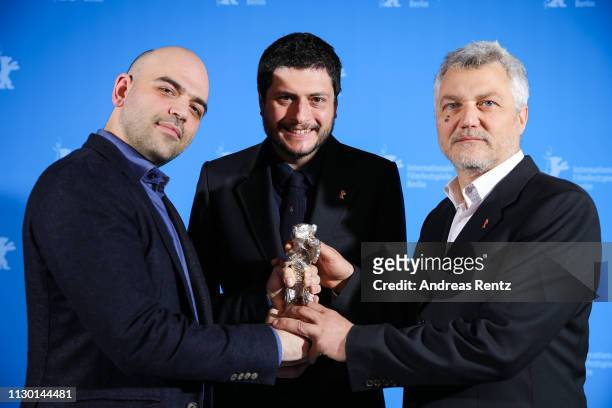 Roberto Saviano, Claudio Giovannesi and Maurizio Braucci, winner of the Silver Bear for Best Screenplay for "Piranhas" pose at the closing ceremony...