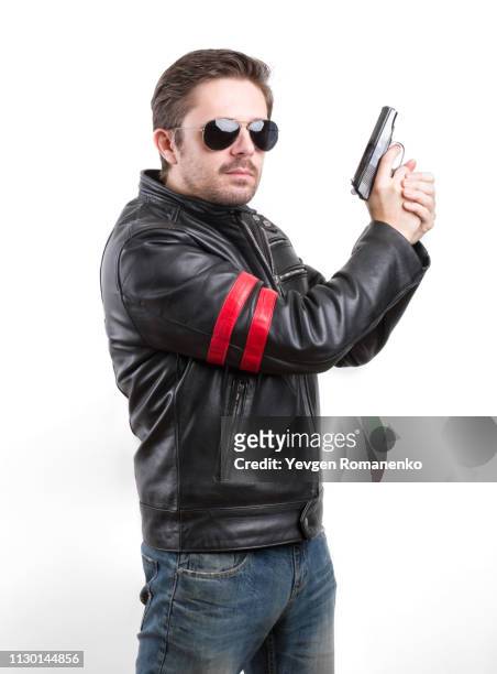 man in black leather jacket and sunglasses with gun - 拳銃 ストックフォトと画像