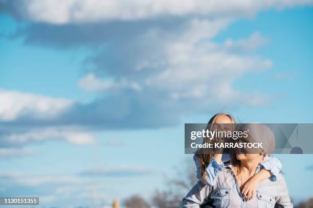a woman with cancer is next to her daughter. a girl is hugging a woman happy - cancerland 2019 bildbanksfoton och bilder
