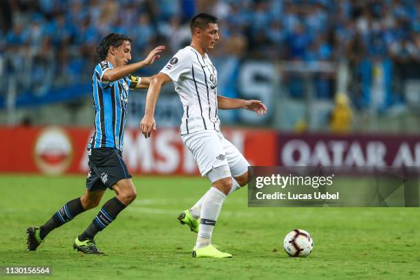 Pedro Geromel of Gremio battles for the ball against Oscar Cardozo of Libertad during the match between Gremio and Libertad, part of Copa Conmebol...