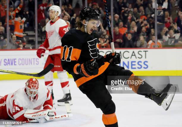 Travis Konecny of the Philadelphia Flyers celebrates his game winning goal as Jonathan Bernier of the Detroit Red Wings reacts at Wells Fargo Center...