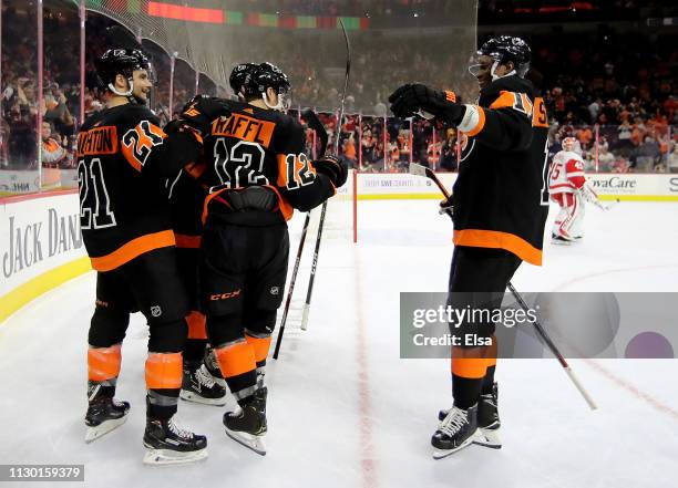 Travis Konecny of the Philadelphia Flyers is congratulated by teammates Scott Laughton,Michael Raffl Wayne Simmonds after Travis Konecny scored the...