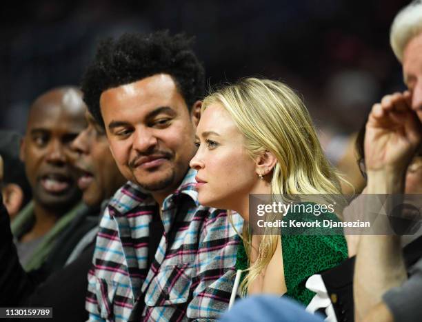 Record producer Alex da Kid and a guest attend the Portland Trail Blazers and Los Angeles Clippers basketball game at Staples Center on March 12,...