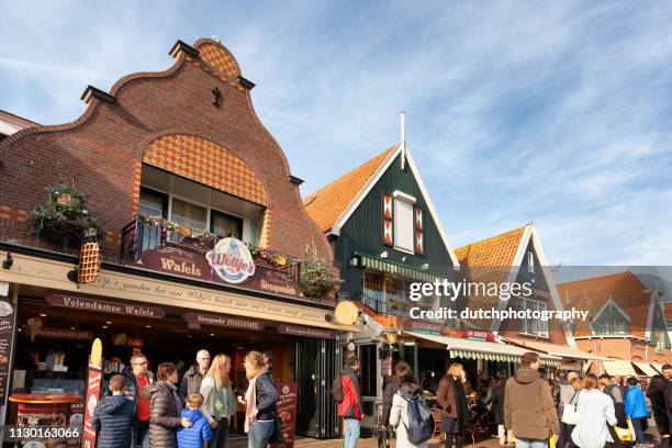 tourists and locals at volendam's boardwalk - volendam stock pictures, royalty-free photos & images