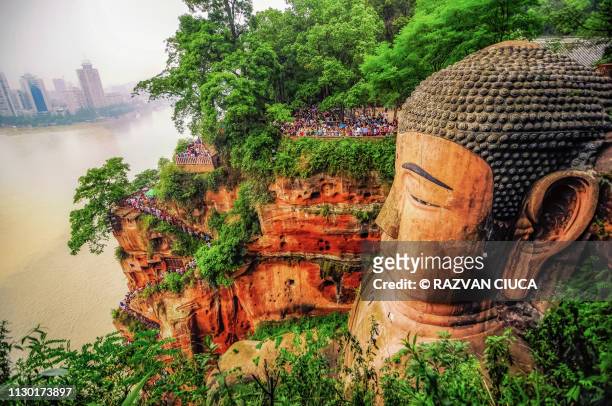 leshan buddha - giant stone heads stock pictures, royalty-free photos & images