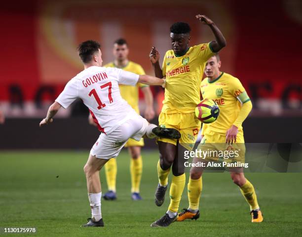 Enock Kwateng of Nantes is tackled by Aleksandr Golovin of Monaco during the Ligue 1 match between AS Monaco and FC Nantes at Stade Louis II on...