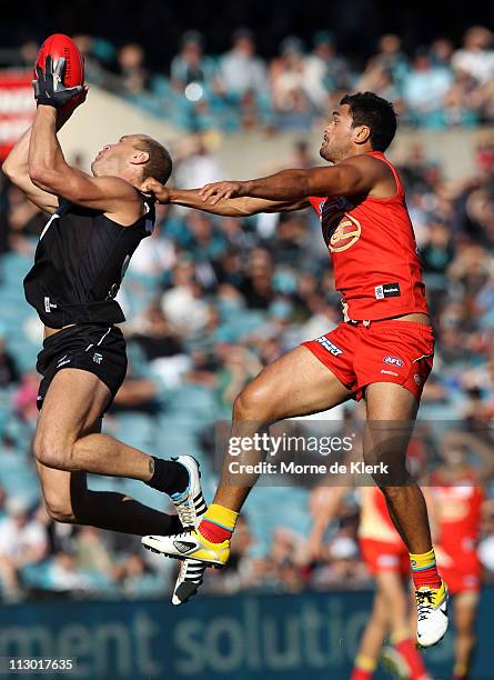 Karmichael Hunt of the Suns and Chad Cornes of the Power compete in the air during the round five AFL match between the Port Adelaide Power and the...