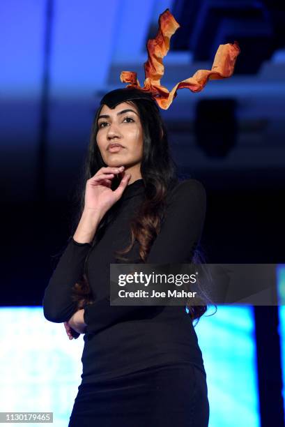 Models walk the runway for Natasha Mobey Millinery at the House of iKons show during London Fashion Week February 2019 at the Millennium Gloucester...