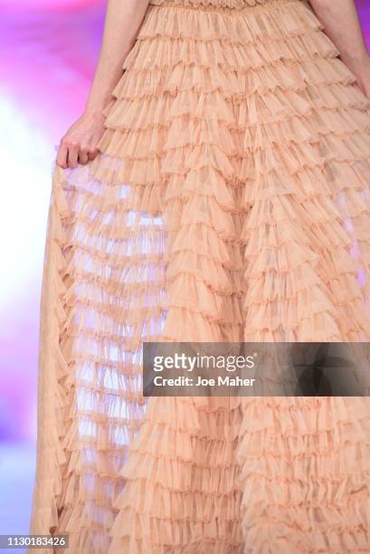 Models, dress detail, walk the runway for Aarti Mahtani at the House of iKons show during London Fashion Week February 2019 at the Millennium...