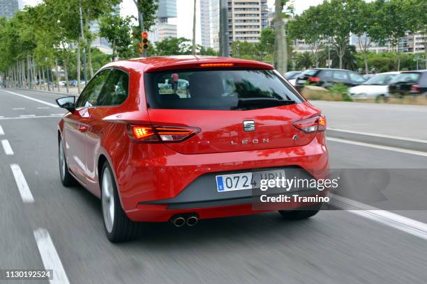 seat leon fr red compact car in motion - car rear imagens e fotografias de stock