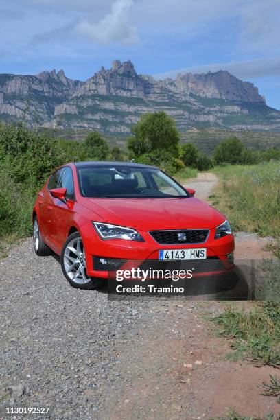 seat leon fr red compact car on the road - compact stock pictures, royalty-free photos & images