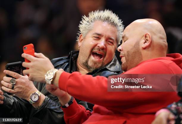 Guy Fieri, TV personality, laughs with rapper Fat Joe during the Taco Bell Skills Challenge as part of the 2019 NBA All-Star Weekend at Spectrum...