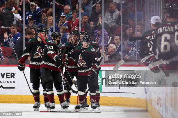 Josh Archibald of the Arizona Coyotes is congratulated by Oliver Ekman-Larsson, Lawson Crouse, Niklas Hjalmarsson and Derek Stepan after Archibald...