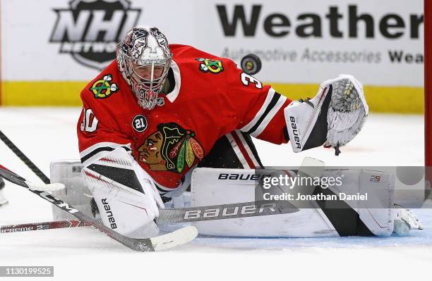 Cam Ward of the Chicago Blackhawks knocks the puck away against the Columbus Blue Jackets at the United Center on February 16, 2019 in Chicago,...