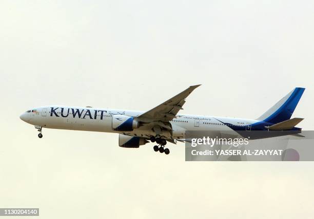 Kuwait Airways Boeing B777 aircraft prepares to land at Kuwait International Airport in Kuwait City on March 13, 2019.