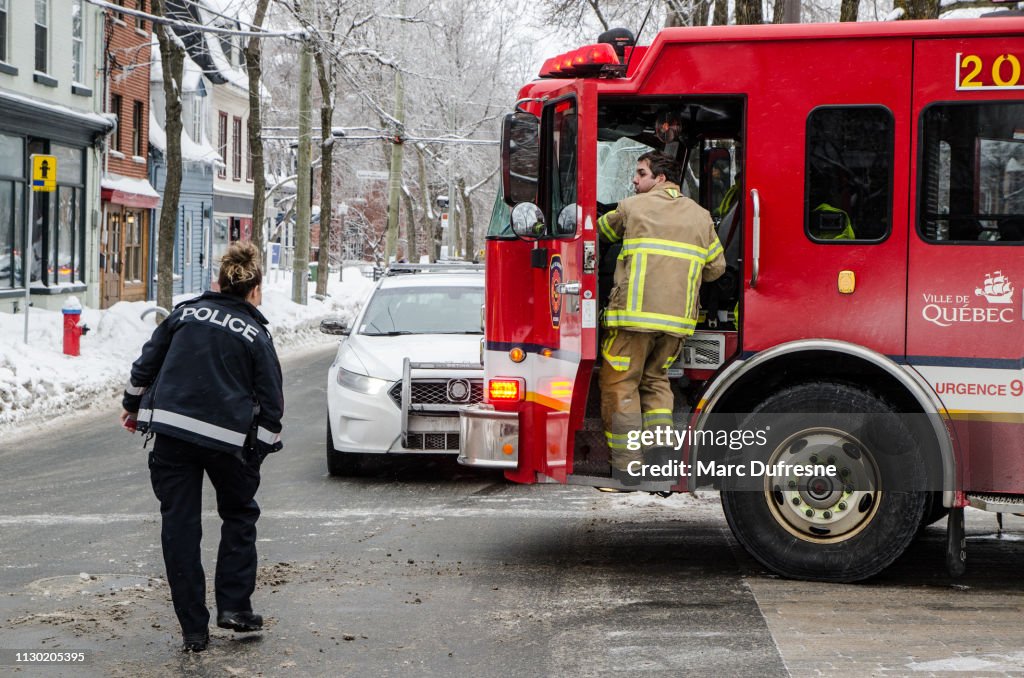 Fireman getting back into firetruck after intervention during winter day