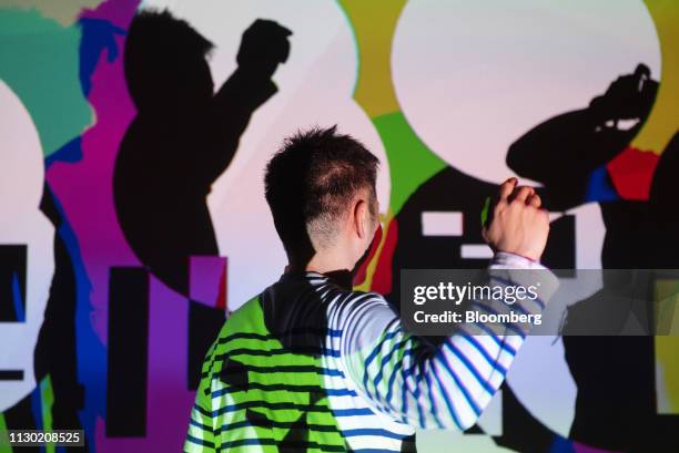 An attendee participates in the Sony Corp. "Fragment Shadow" interactive experience at the South By Southwest conference in Austin, Texas, U.S., on...