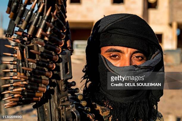 Fighter with the Syrian Democratic Forces is pictured in the town of Baghouz, on the frontline of fighting to expel the Islamic State group from the...