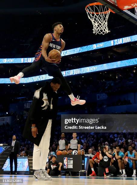 Dennis Smith, Jr. #5 of the New York Knicks attempts a dunk over Dwyane Wade during the AT&T Slam Dunk as part of the 2019 NBA All-Star Weekend at...