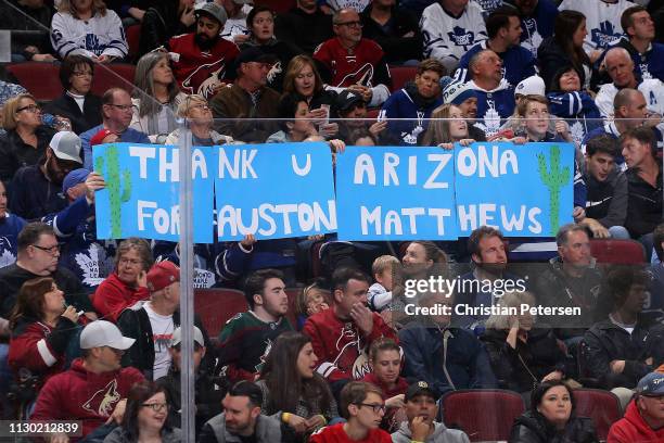 Fans hold up a "thank you Arizona" sign for Auston Matthews of the Toronto Maple Leafs during the third period of the NHL game against the Arizona...