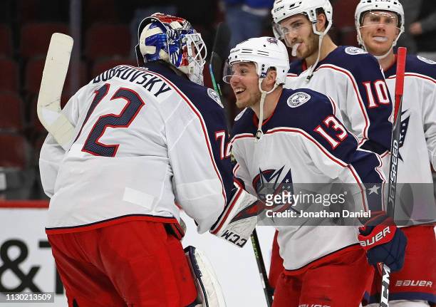 Sergei Bobrovsky of the Columbus Blue Jackets is congratulated by Cam Atkinson after a win against the Chicago Blackhawks at the United Center on...