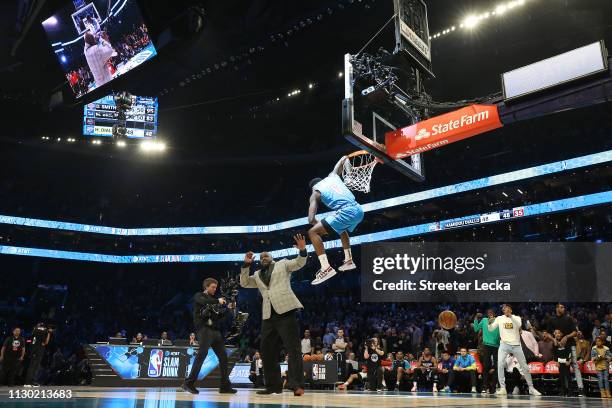 Shaquille O'Neal reacts as Hamidou Diallo of the Oklahoma City Thunder dunks over him during the AT&T Slam Dunk as part of the 2019 NBA All-Star...