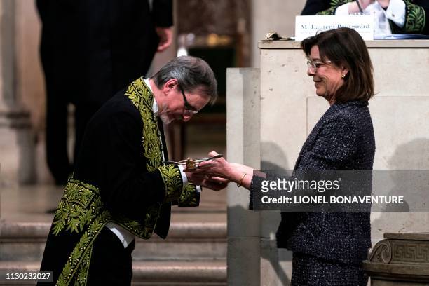 Czech former dancer and choreographer Jiri Kylian , receives a sword by Princess Caroline of Hanover during his induction ceremony at the Academy of...