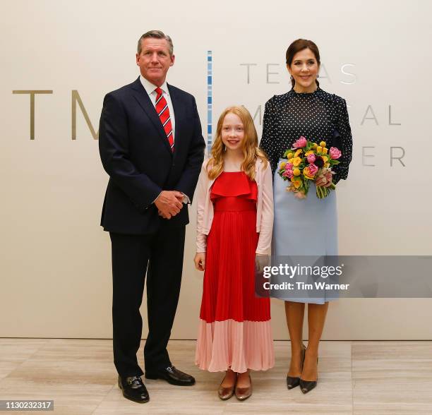 Her Royal Highness Crown Princess Mary of Denmark receives flowers from a flower girl before an event highlighting an exploration of life science...