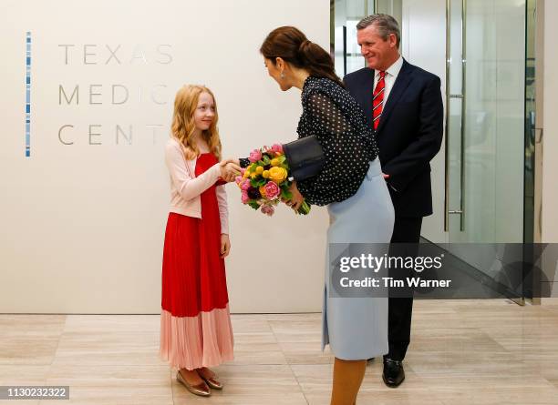 Her Royal Highness Crown Princess Mary of Denmark receives flowers from a flower girl before an event highlighting an exploration of life science...