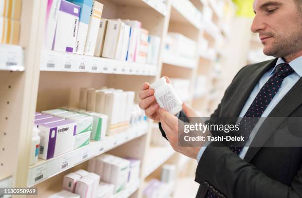 man shopping at drugstore - probiotic stock pictures, royalty-free photos & images