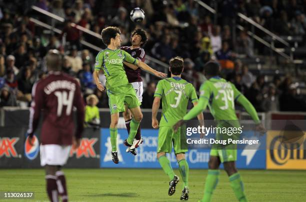 Alvaro Fernandez of the Seattle Sounders FC and Kosuke Kimura of the Colorado Rapids vie for a head ball as Omar Cummings of the Colorado Rapids and...