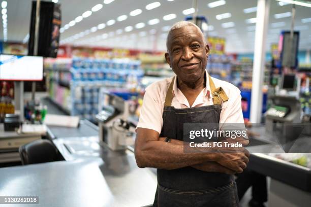 afro senior man business owner / employee at supermarket - older black people shopping stock pictures, royalty-free photos & images
