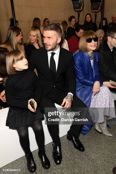 Harper Beckham, David Beckham and Anna Wintour attend the Victoria Beckham show during London Fashion Week February 2019 on February 17, 2019 in...