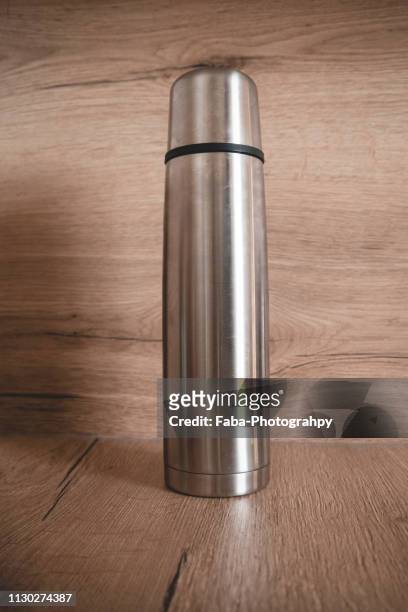 thermos on wooden background - wärme stock pictures, royalty-free photos & images