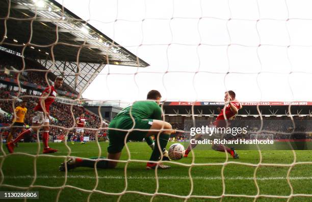 Goalkeeper Frank Fielding and Tomas Kalas of Bristol City fail to stop Ivan Cavaleiro of Wolverhampton Wanderers from scoring his team's first goal...