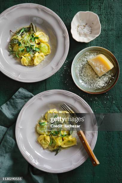spinach and ricotta ravioli with sage butter - tortellini stock pictures, royalty-free photos & images