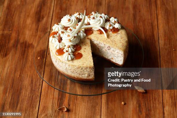 almond cheesecake decorated with whipped cream and salted caramel - gezout stockfoto's en -beelden