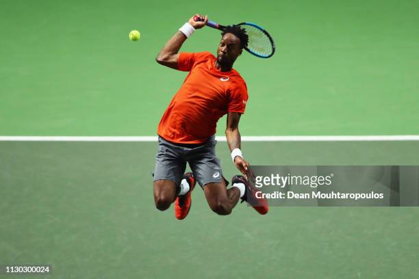 Gael Monfils of France smashes a forehand return as he jumps in the air to Stan Wawrinka of Switzerland in their Mens Final during Day 7 of the ABN...