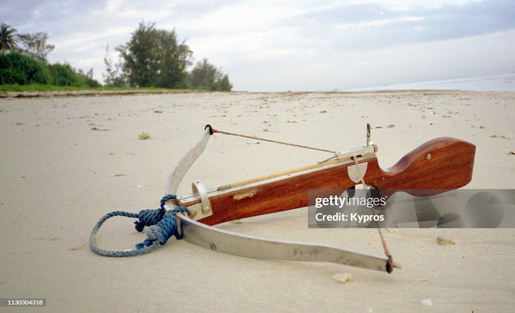 Africa, Tanzania, Dar Es Salaam, 2000: View Of Home-Made Wooden Crossbow On Beach For Self-Defence By Explorer. Purchased In Kit Form, Missing Parts.